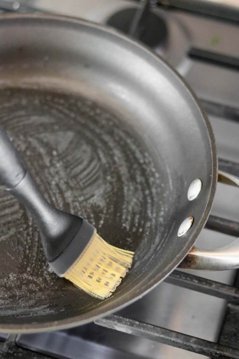 Melted butter in a pan with a silicon brush.