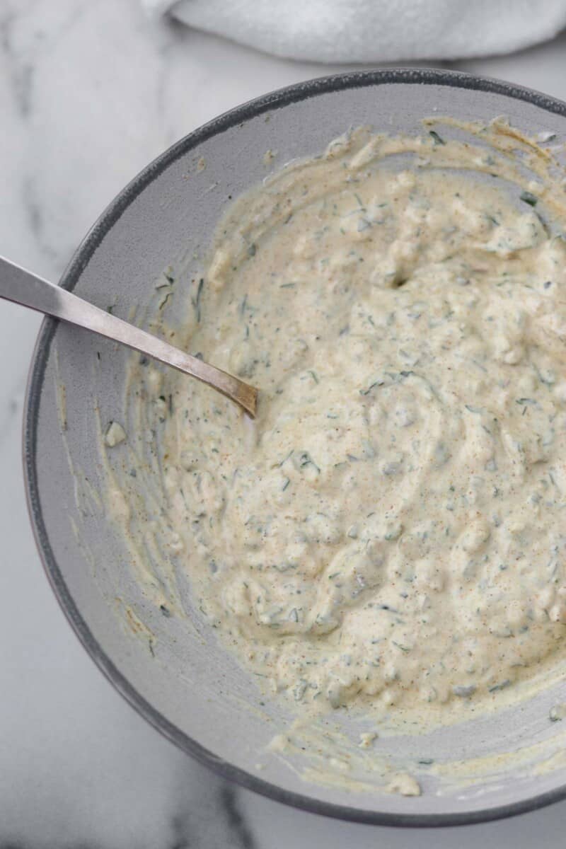 Danish remoulade in a bowl with a spoon.