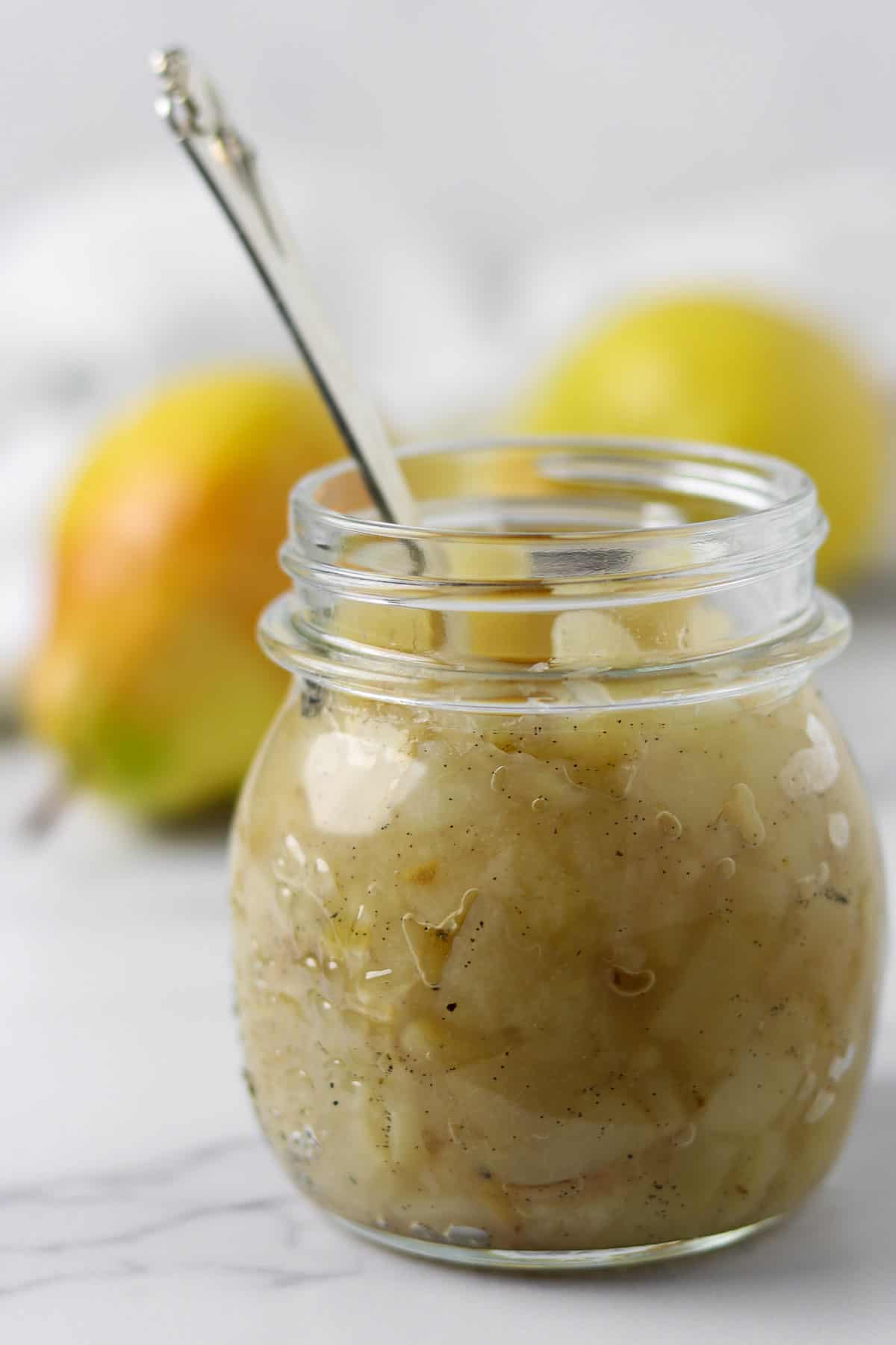 Close up of a glass jar of pear compote.