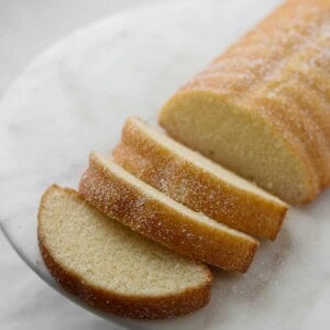 Sliced Swedish Almond Cake on a marble plate