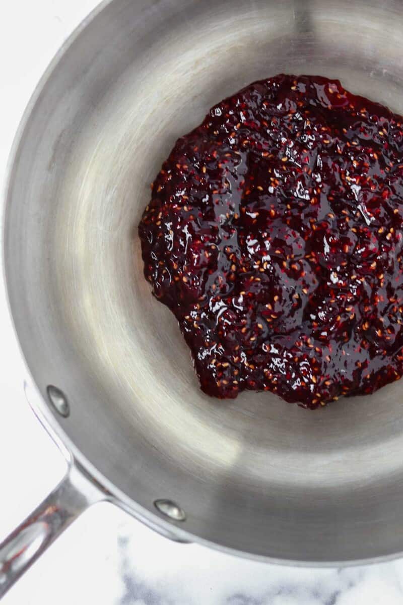 Raspberry jam in a pan.