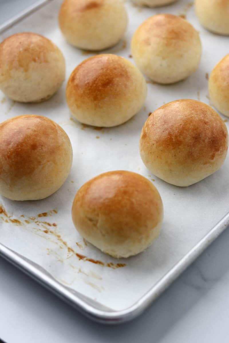 Baked round buns on a baking sheet.