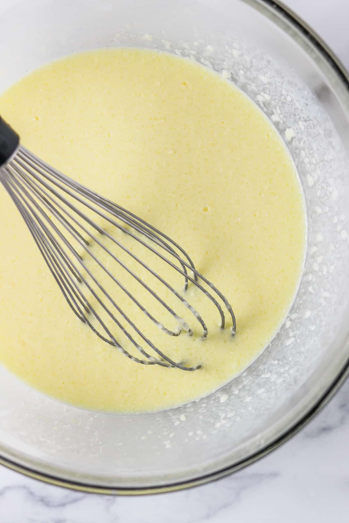 Waffle batter with a whisk.