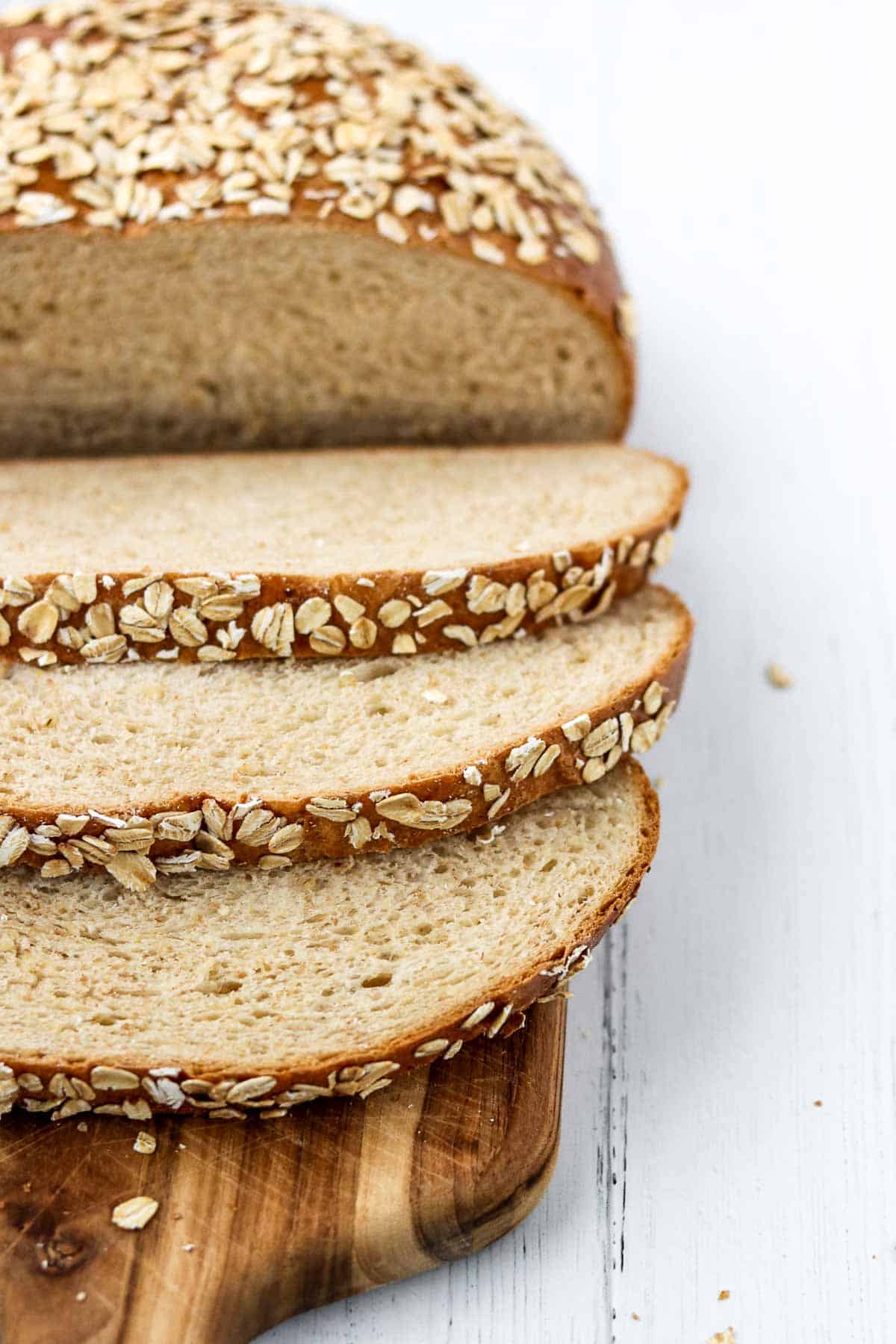 Danish oat bread sliced on a cutting board.