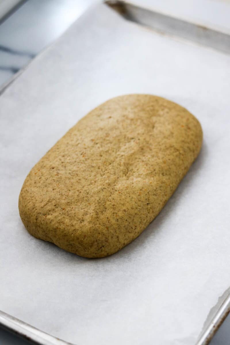 Rye bread dough on a baking sheet.