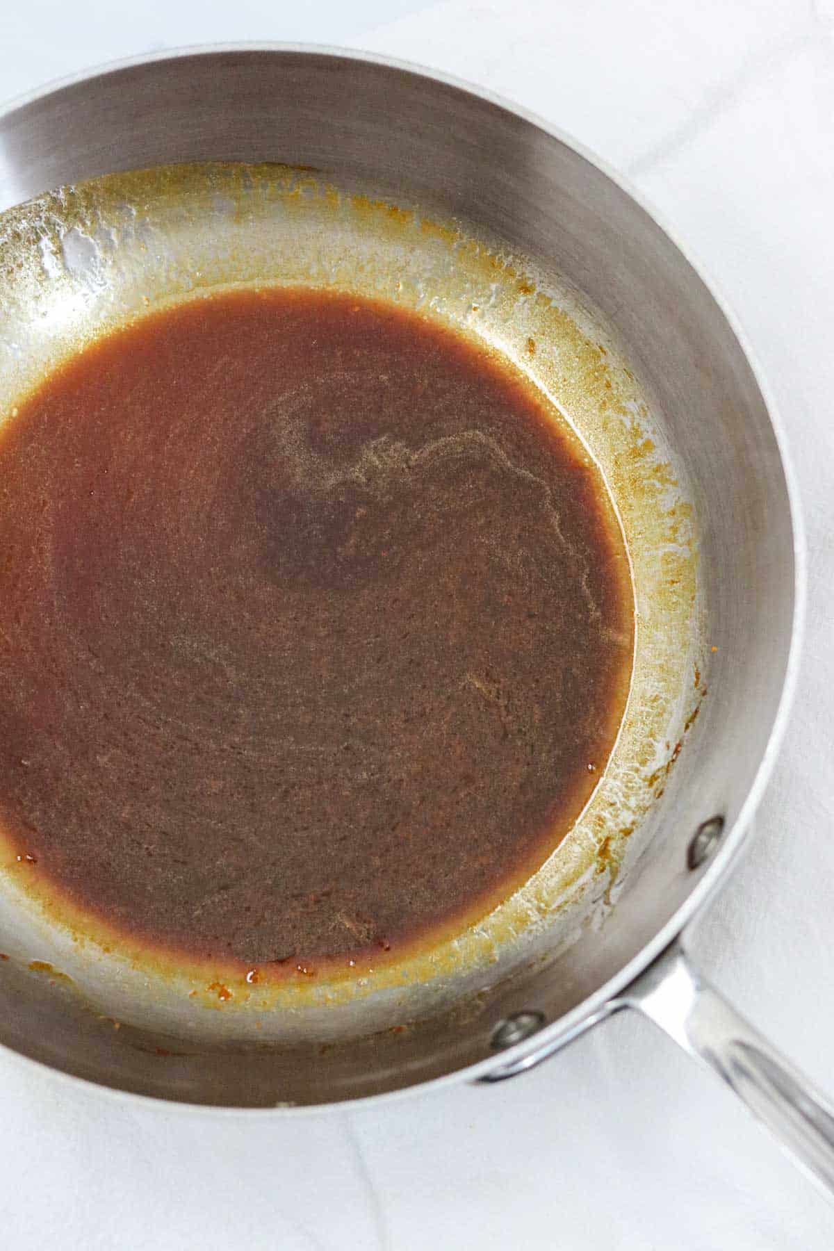 Molasses and butter mixture in a metal pan.