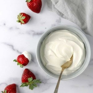Whipped Vanilla Cream Skyr in a bowl next to strawberries.