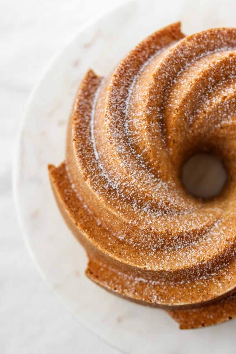 Overhead view of a bundt cake dusted with powdered sugar.