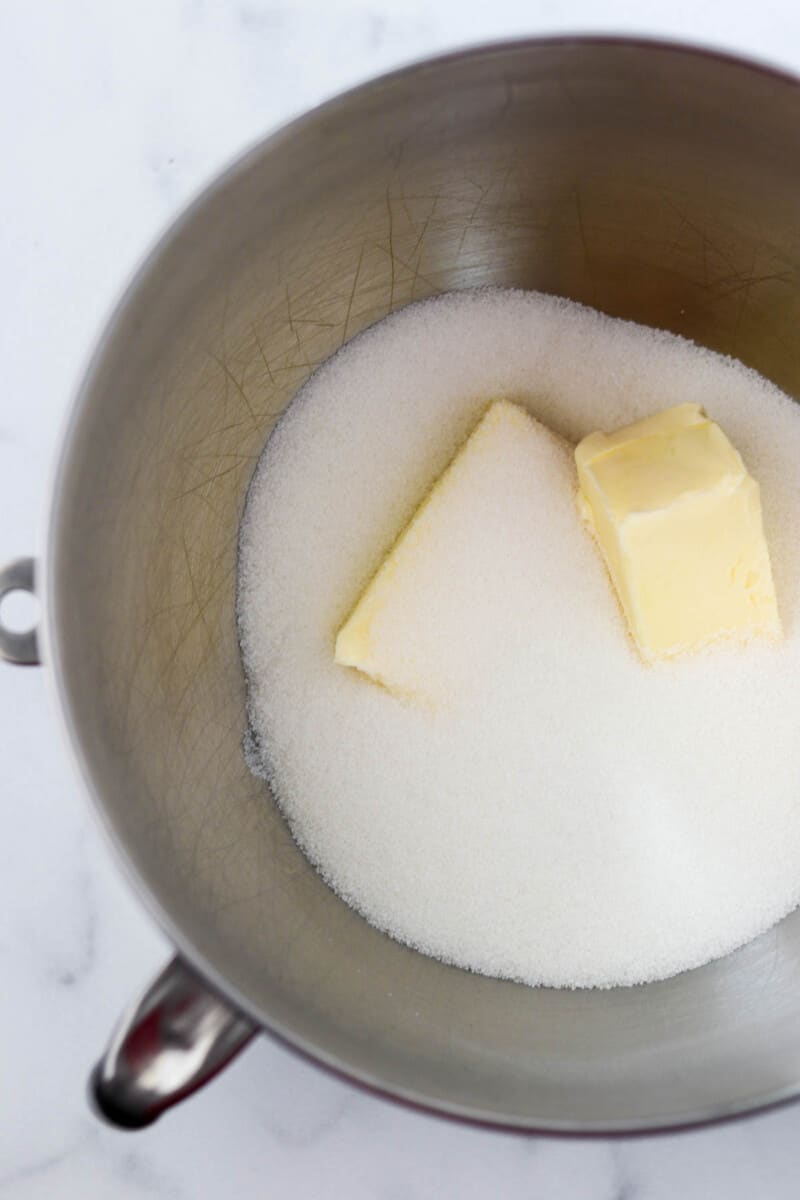 Butter and sugar in a metal bowl.