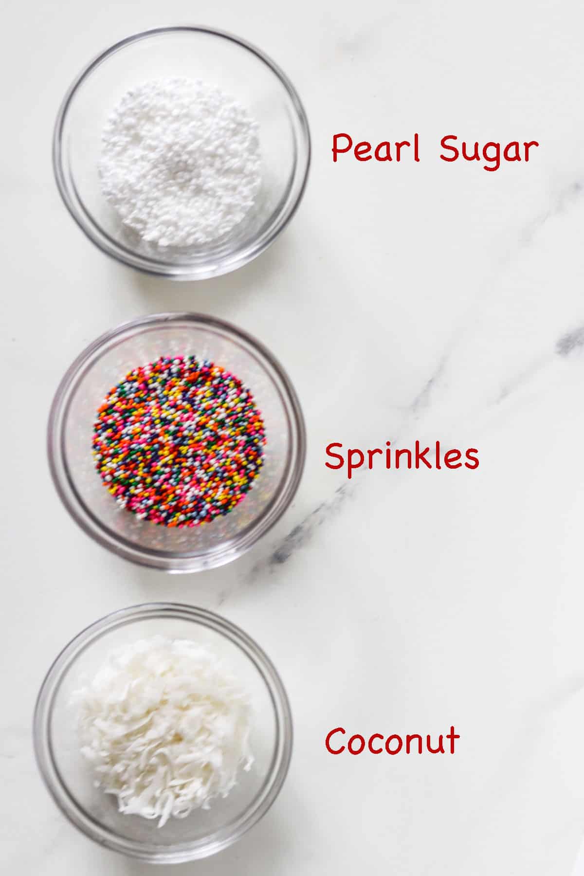 Labeled bowls of pearl sugar, sprinkles and coconut.