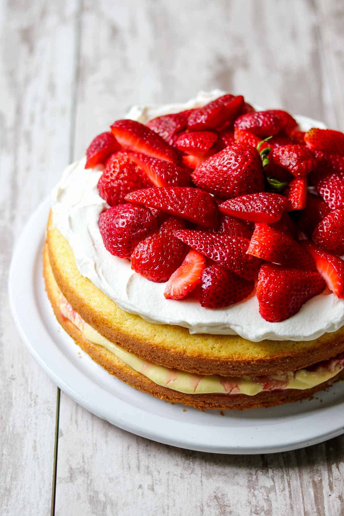 Scandinavian Strawberry Cream Cake on a wood surface.