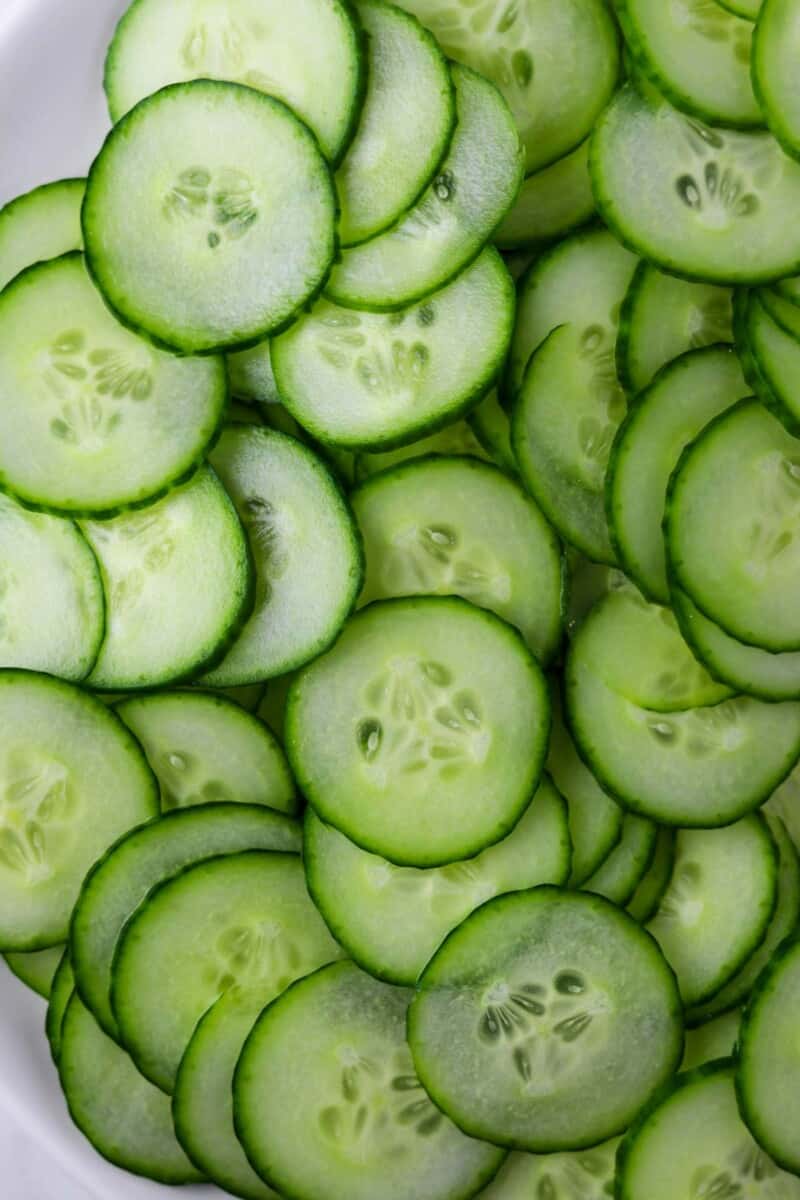 Sliced cucumbers on a white plate.