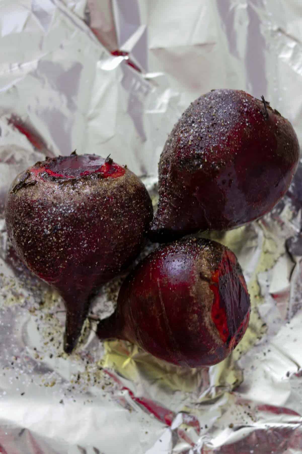 Roasted beets on a piece of foil.