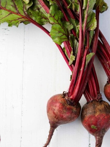 Beets on a white wooden surface.