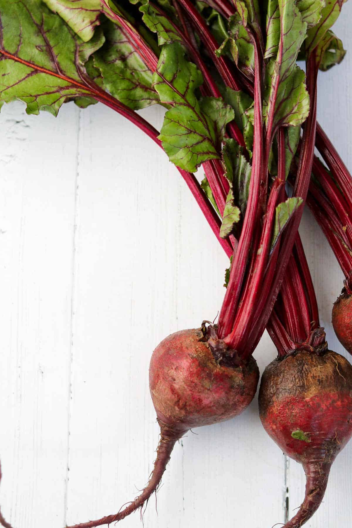 Beets on a white wooden surface.