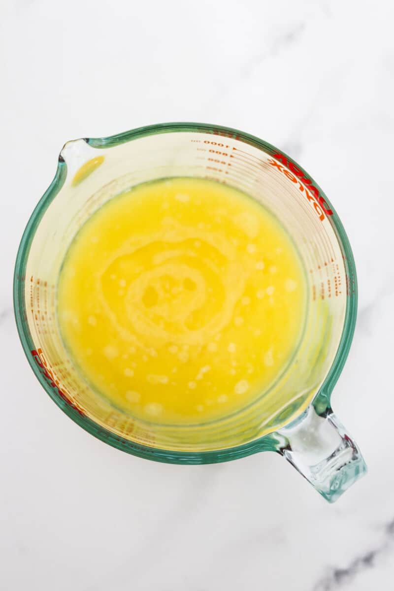 Melted butter in a measuring cup.