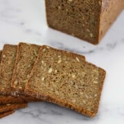 Sliced rye bread on a marble surface.