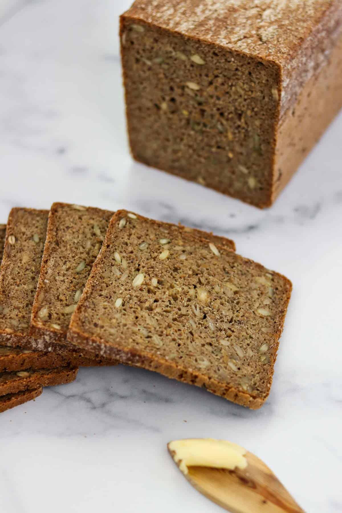 Sliced rye bread on a marble surface.