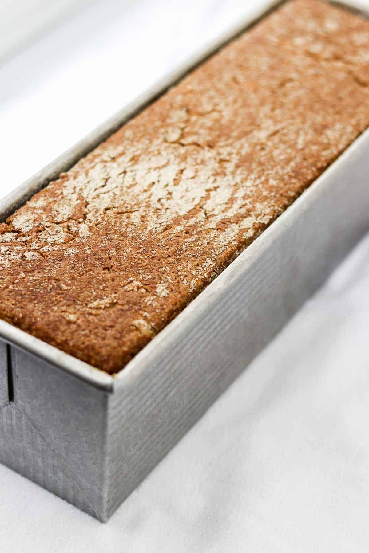 Danish rye bread in a loaf pan.
