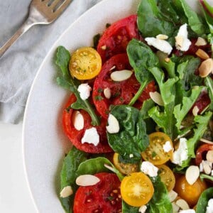 Swedish Marinated Tomato and Goat Cheese Salad next to a fork and napkin.