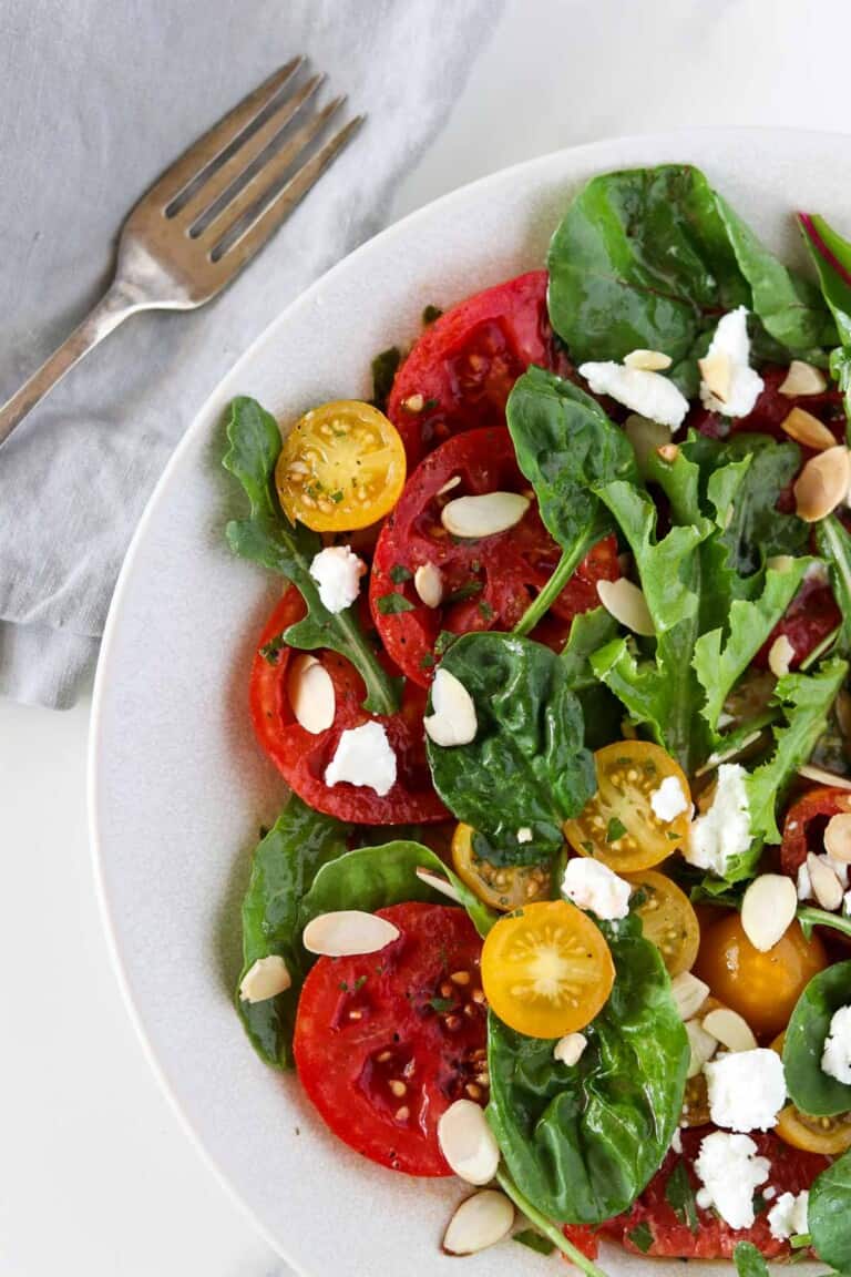 Swedish Marinated Tomato and Goat Cheese Salad next to a fork and napkin.
