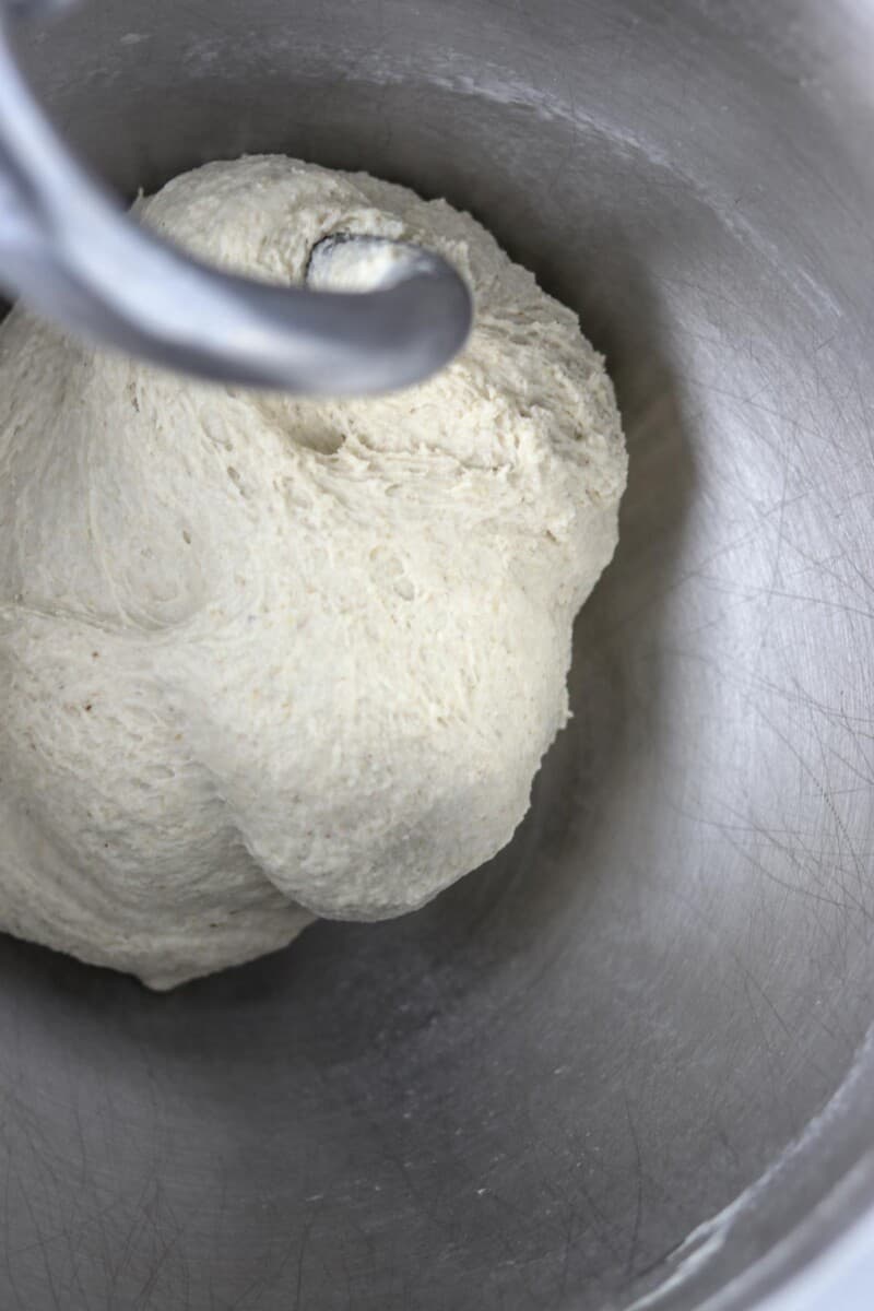 Flatbread dough in a metal bowl.