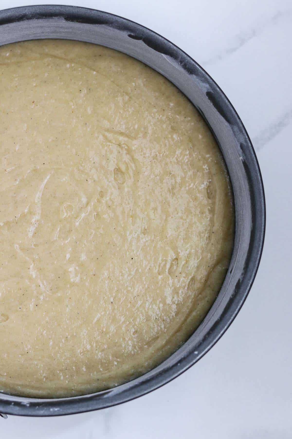 Cake batter in a cake pan.