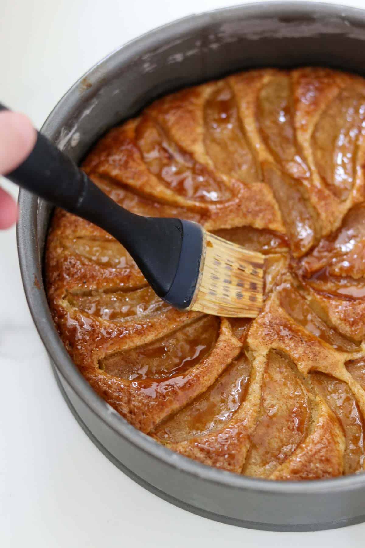 Brushing syrup on a Swedish Apple Cake.