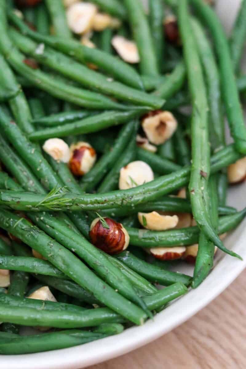 Close up of Green Beans with Dill Caper Butter and Toasted Hazelnuts