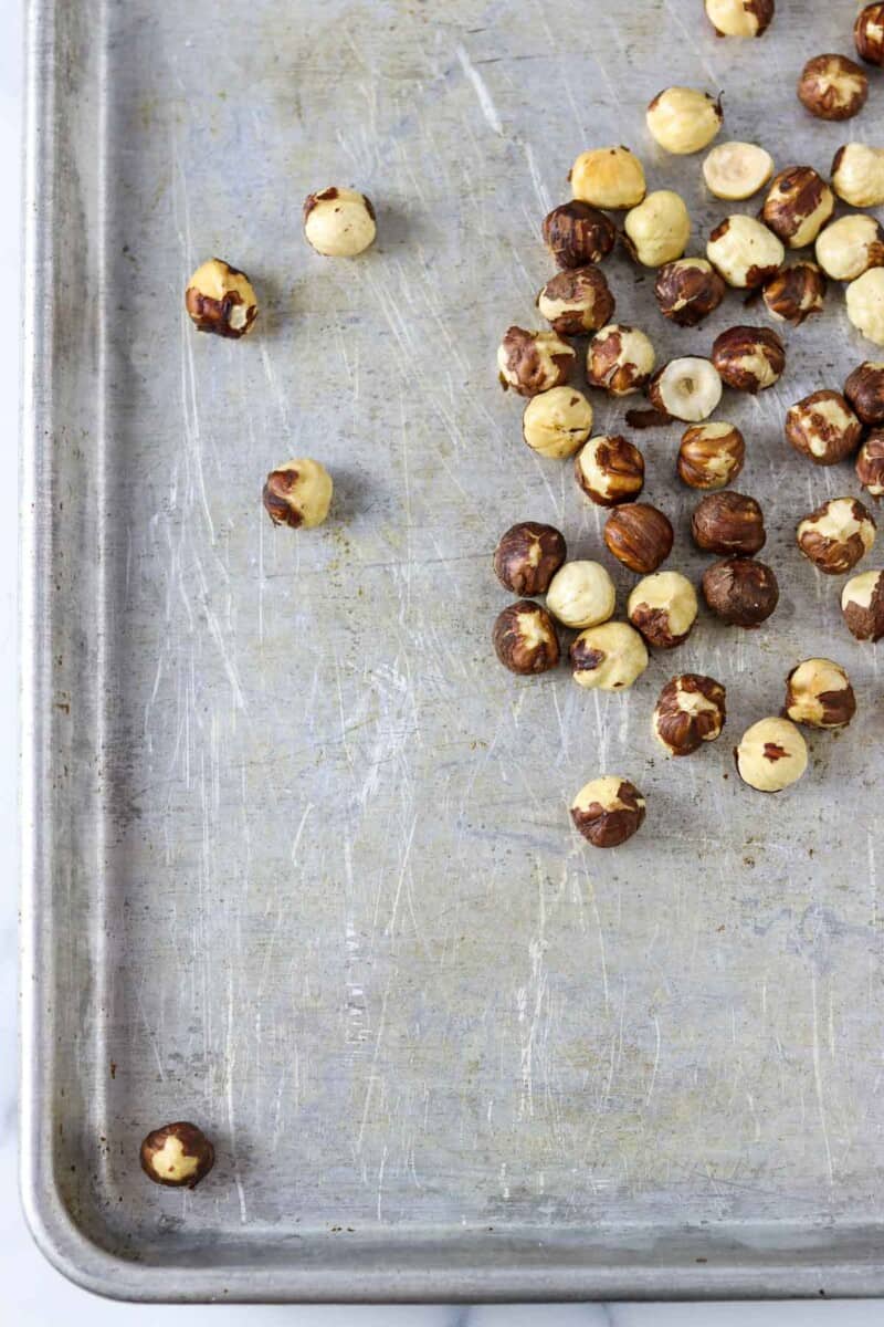 Hazelnuts on a sheet pan.