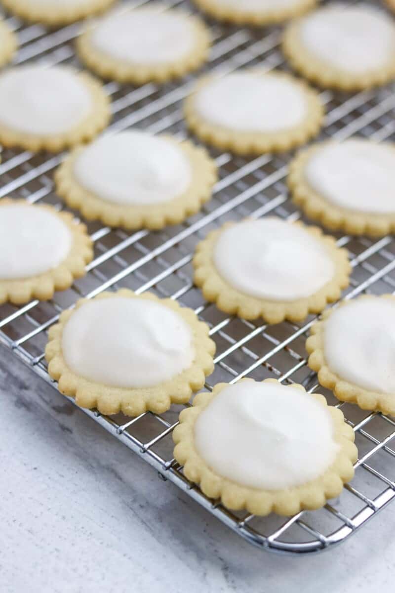 Frosted Nordic Lemon Wafers on a cooling rack.