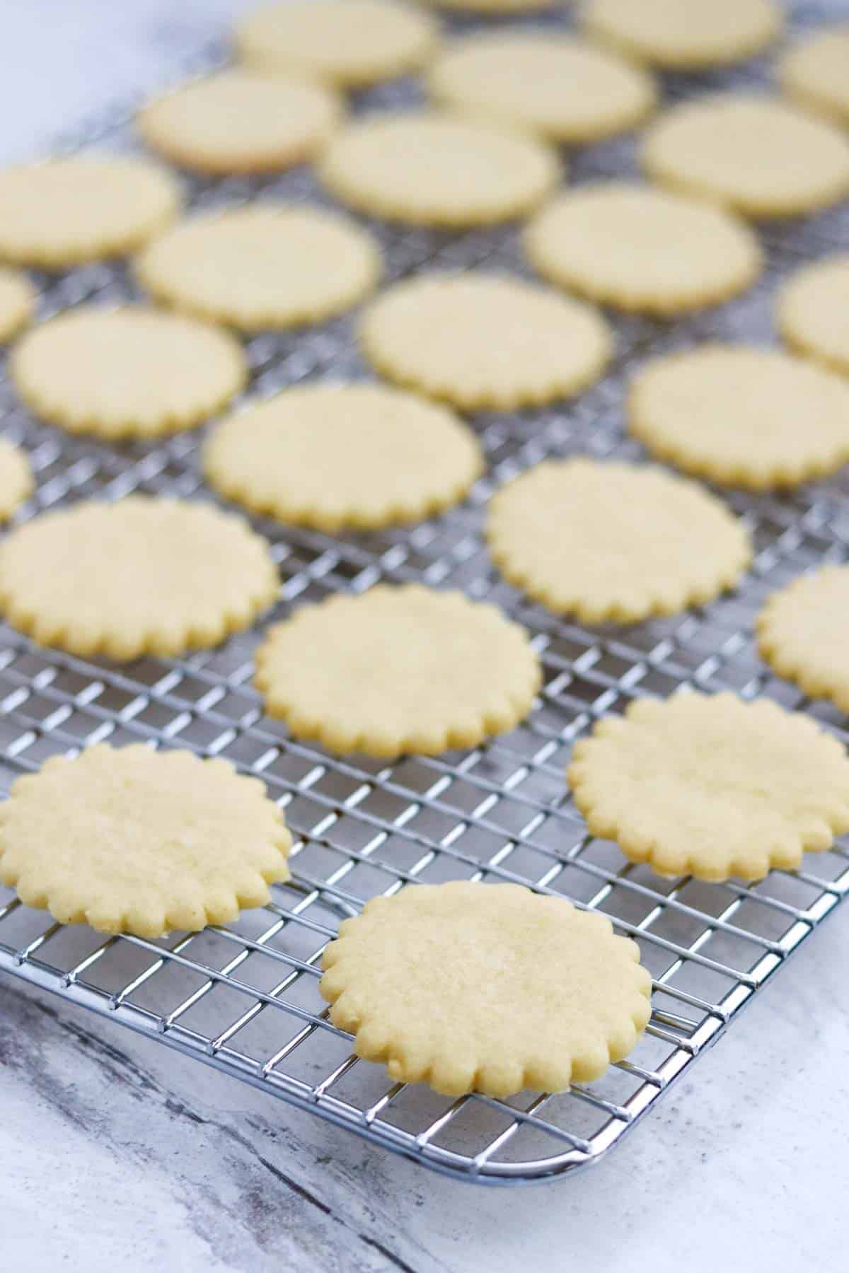 Baked but unfrosted Nordic Lemon Wafers on a cooling rack.