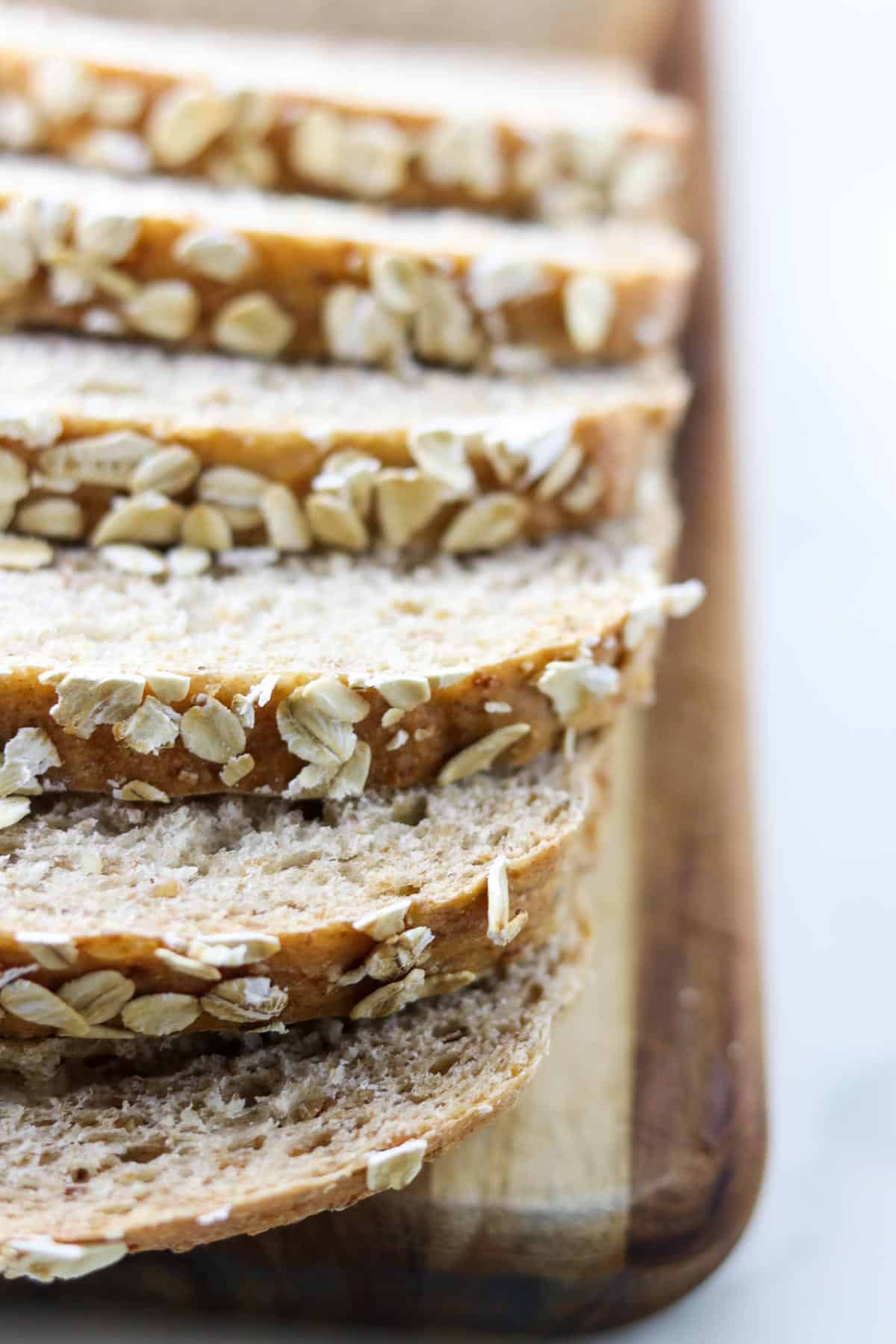 Close up of sliced multigrain bread with oats on top.
