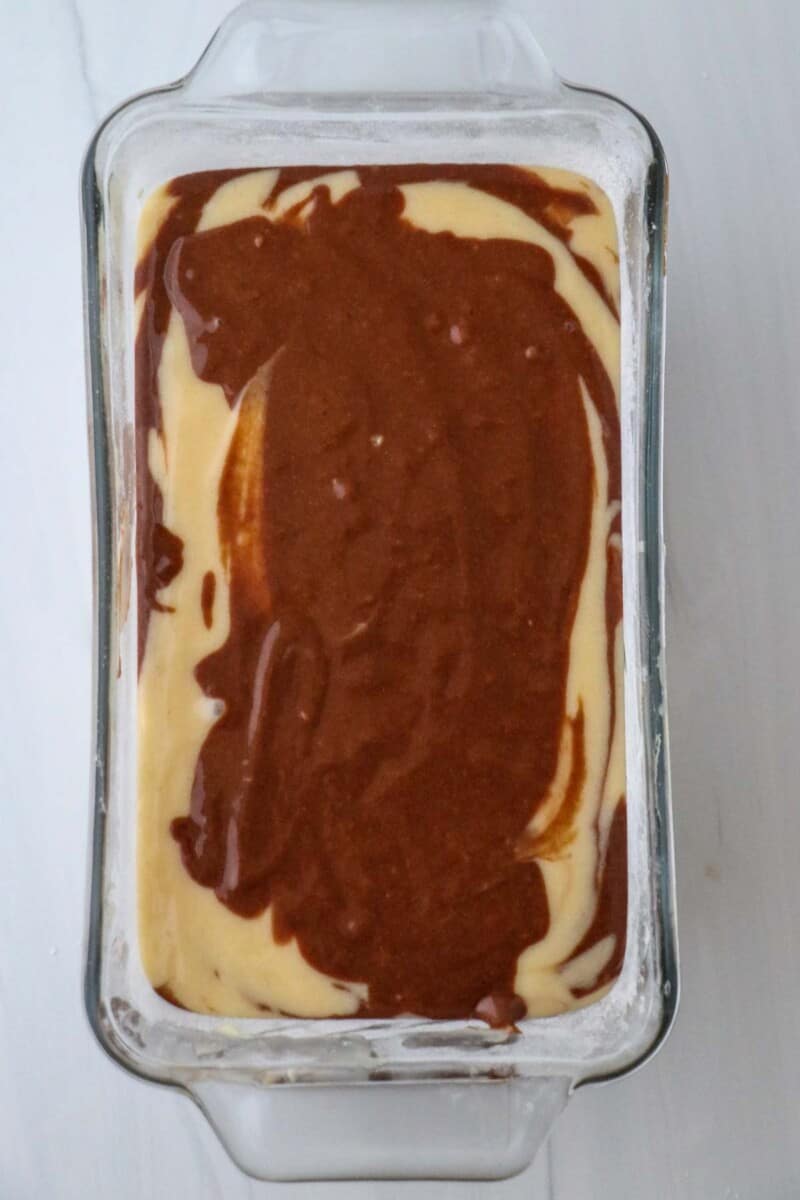 Marble cake batter in a loaf pan.