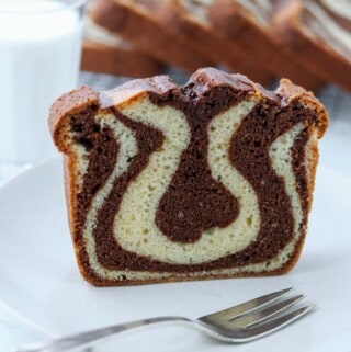 Swedish Tiger Cake on a plate with a fork next to a glass of milk.