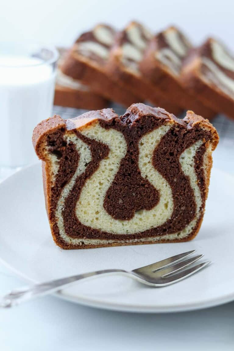 Swedish Tiger Cake on a plate with a fork next to a glass of milk.