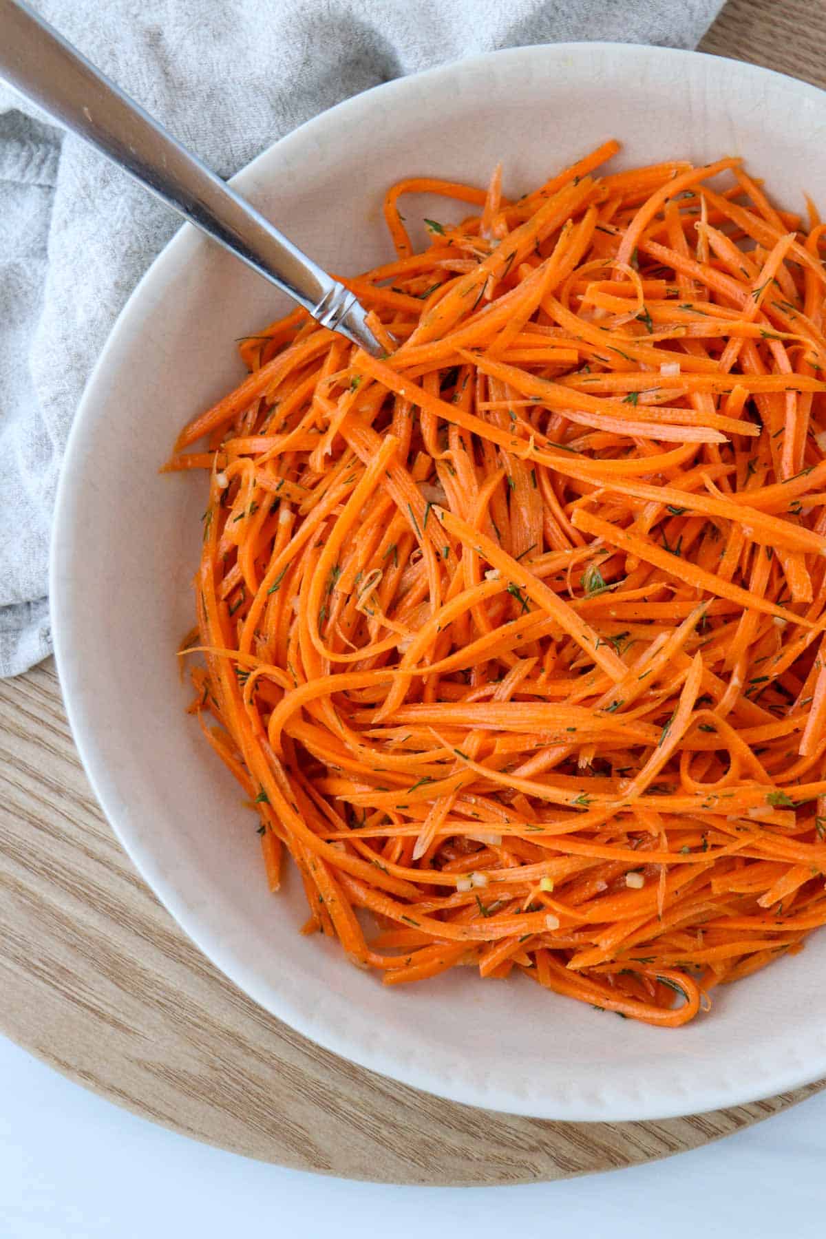 Nordic Carrot Salad with Lemon and Dill in a bowl with a spoon.