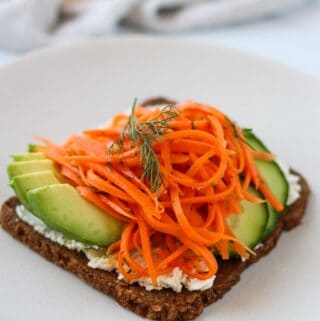 Side view of Carrot Salad Smørrebrød on a plate.