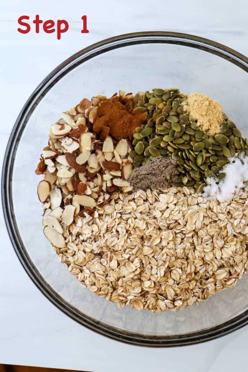 Unmixed dry ingredients for Homemade Cardamom Granola with Almonds in a glass bowl.
