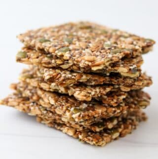 Stack of Norwegian Seed Crispbread on a white surface.