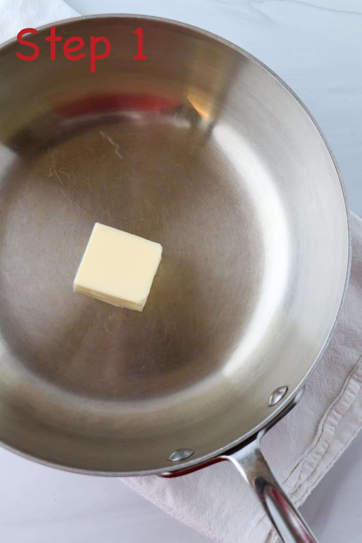 Cube of butter in a saucepan.