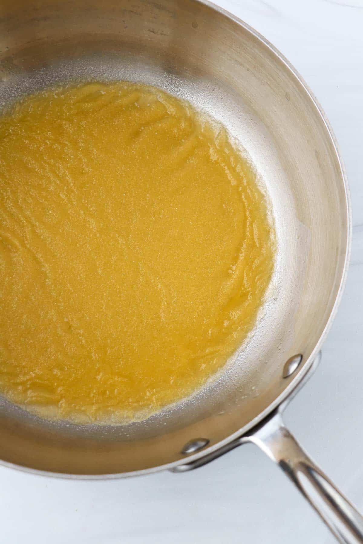 Orange juice and gelatin in a saucepan.