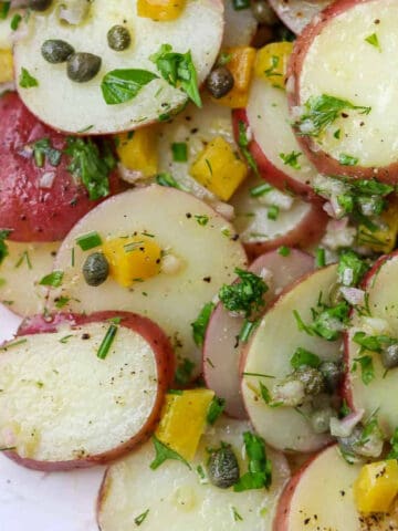 Close up of Herbed Potato Salad with Capers and Pickled Golden Beets.