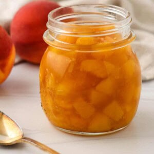 Close up of a jar of Quick and Easy Peach Compote.