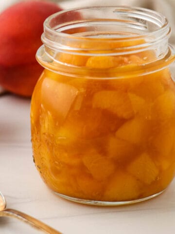 Close up of a jar of Quick and Easy Peach Compote.