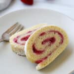 Close up of Strawberry Roll Cake slices next to a fork.