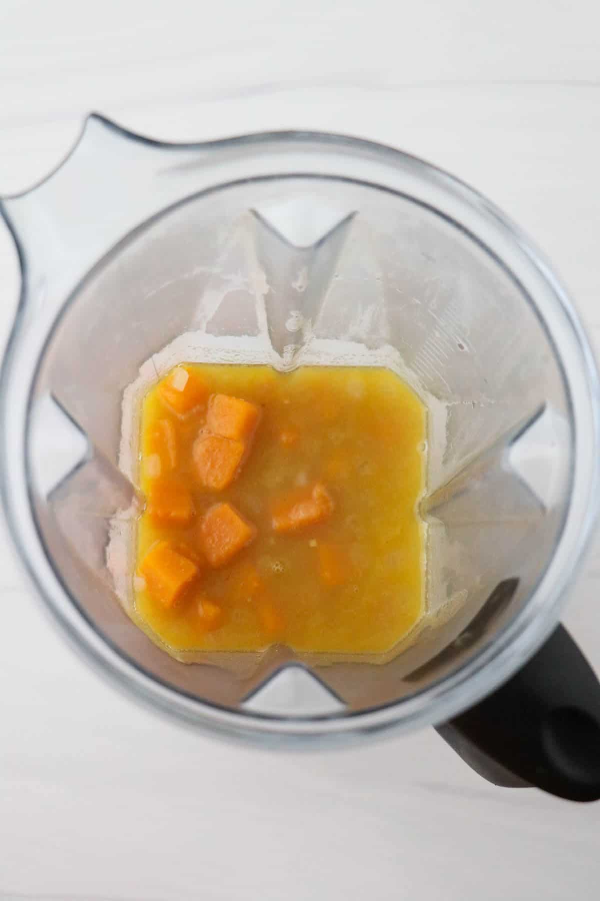 Overhead view of chunky butternut squash soup in a blender.