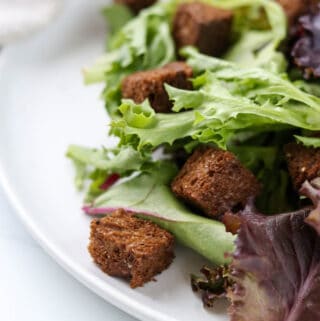 Close up of rye croutons in a salad.