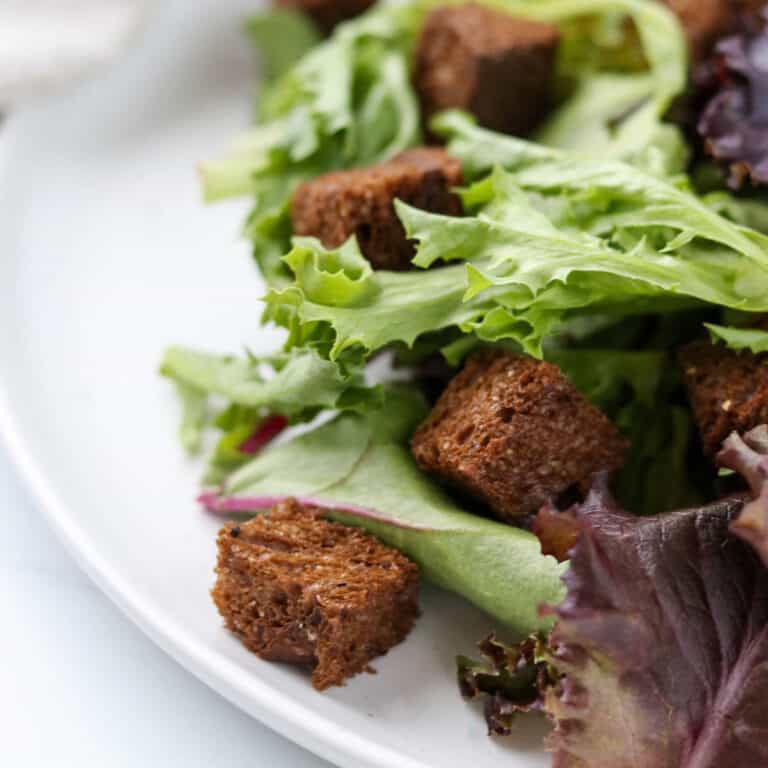 Close up of rye croutons in a salad.