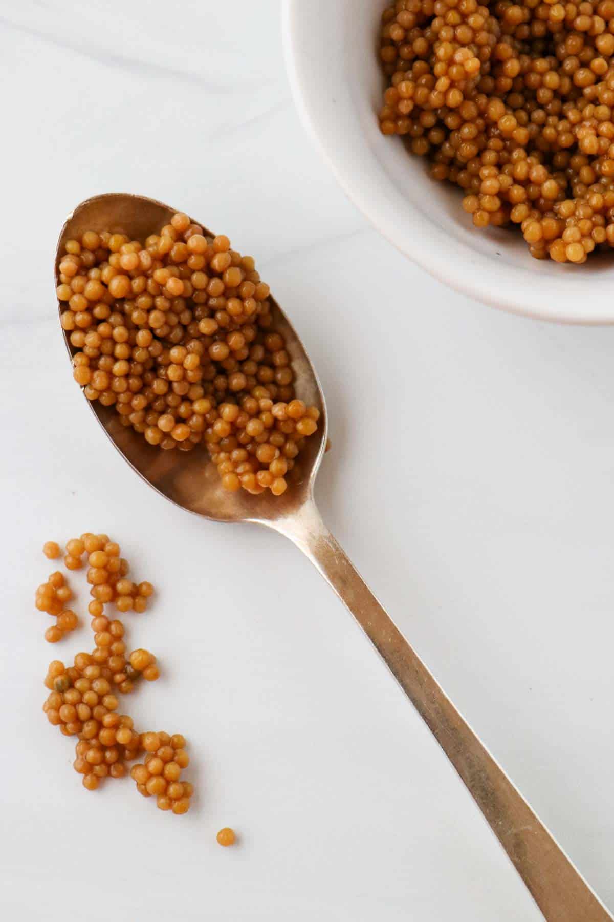 Pickled Mustard Seeds on a spoon.